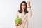 Young beautiful chinese woman holding watermelon standing over isolated white background annoyed and frustrated shouting with