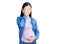 Young beautiful chinese woman pregnant expecting baby covering one eye with hand, confident smile on face and surprise emotion