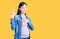 Young beautiful chinese woman pregnant expecting baby smiling swearing with hand on chest and fingers up, making a loyalty promise