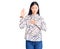 Young beautiful chinese woman wearing casual shirt swearing with hand on chest and open palm, making a loyalty promise oath