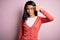 Young beautiful chinese woman wearing casual sweater over isolated pink background pointing unhappy to pimple on forehead, ugly