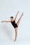 Young beautiful contemporary dancer posing over white background. Copy space.