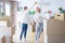 Young beautiful couple dancing at new home around cardboard boxes