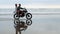 Young beautiful couple hipsters riding retro motorcycle on the beach, outdoor portrait, riding guy and girl, travel