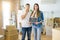 Young beautiful couple holding blackboard with new home text at new house cover mouth with hand shocked with shame for mistake,