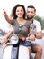 Young beautiful couple riding on motorbike city street.