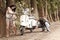 Young beautiful couple with scooter along dirt road