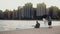 Young Beautiful couple on the shore of Michigan lake, Chicago, America. Woman draw, man play guitar.