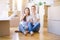 Young beautiful couple sitting on the floor at new home around cardboard boxes cover mouth with hand shocked with shame for