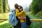 Young beautiful couple smiling, embracing, enjoying mountains lanscape.