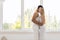 Young Beautiful Couple Stand Near Window Embrace, Happy Smile Hispanic Man And Woman