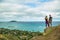 Young beautiful couple standing on a cliff while hiking the Inst