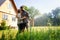 Young beautiful couple watering the plants in a country house, summer, work in the garden, love and summer concept