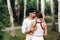 A young beautiful couple in white clothes against the background of a birch grove.Portrait of people in love in a Park in nature