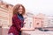 Young beautiful curly teen girl coquettishly smiles while standing on the Moika River in St. Petersburg, Russia