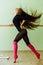 Young beautiful dancer posing in studio wit Ballet bar on tiptoe. Modern brunette.