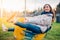 Young beautiful dreaming woman playing riding with rocking spring horse