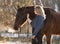 Young beautiful elegance woman posing with horse