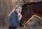 Young beautiful elegance woman posing with horse