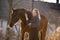 Young beautiful elegance woman posing with horse