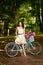 Young beautiful, elegantly dressed woman with retro bicycle. Healthy, cycling.