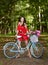 Young beautiful, elegantly dressed woman with retro bicycle. Healthy, cycling.