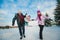 Young beautiful family in bright clothes winter fun jumping and running, snow, lifestyle, winter holidays