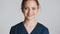 Young beautiful female doctor happily looking in camera over white background