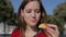 Young beautiful female eating tapas at street