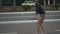 Young beautiful female hipster riding on the street on skateboard or longboard at day