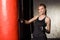 Young, beautiful and fit blond lady is working out in a gym decorated in loft style.