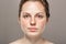 Young beautiful freckles woman face portrait with healthy skin