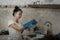 Young beautiful frustrated and upset Asian woman in domestic chores stress - cute overwhelmed and stressed Japanese girl washing
