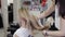 Young beautiful girl in beauty salon. Hairdresser stylist makes girl`s hair