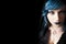 Young beautiful girl blue hair and make-up. Free left space black background