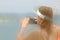 A young beautiful girl with a brown-haired woman takes a photo of a smartphone on the sea from the side of a sailing yacht. A fasc