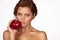 Young beautiful girl with dark curly hair, bare shoulders and neck, holding big red apple to enjoy the taste and are dieting,