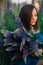 Young beautiful girl in defocus with a large bouquet of purple lupins in a field in the grass. Nature concept. Close-up