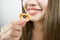 young beautiful girl eating bagels, close-up, crop photo.Attractive brunette sexy woman eating a delicious donut