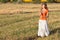 Young beautiful girl in the field with ears in the hand