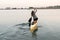 Young beautiful girl is floating on a reservoir in a canoe. The concept of sport and a healthy lifestyle