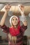 Young beautiful girl hangs Christmas decorations