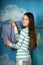 Young beautiful girl hangs clothes