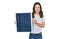 Young beautiful girl holding photovoltaic solar panel looking positive and happy standing and smiling with a confident smile
