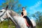 Young beautiful girl on horse walk