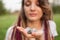 Young beautiful girl with long dreadlocks holds in hands 5 natural stones rose quarz, rhinestone, angelite, anyolite