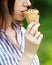 Young beautiful girl with long flowing hair eat ice cream. Bright sunny day. Natural background. Soft focus