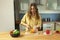 Young beautiful girl with long hair slices sweet pepper.