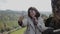 Young beautiful girl making selfie in front of beautiful mountain landscape. Close-up. Bastei. Saxon Switzerland