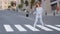 Young beautiful girl model business woman student in stylish blue suit with black handbag walking jumping circling